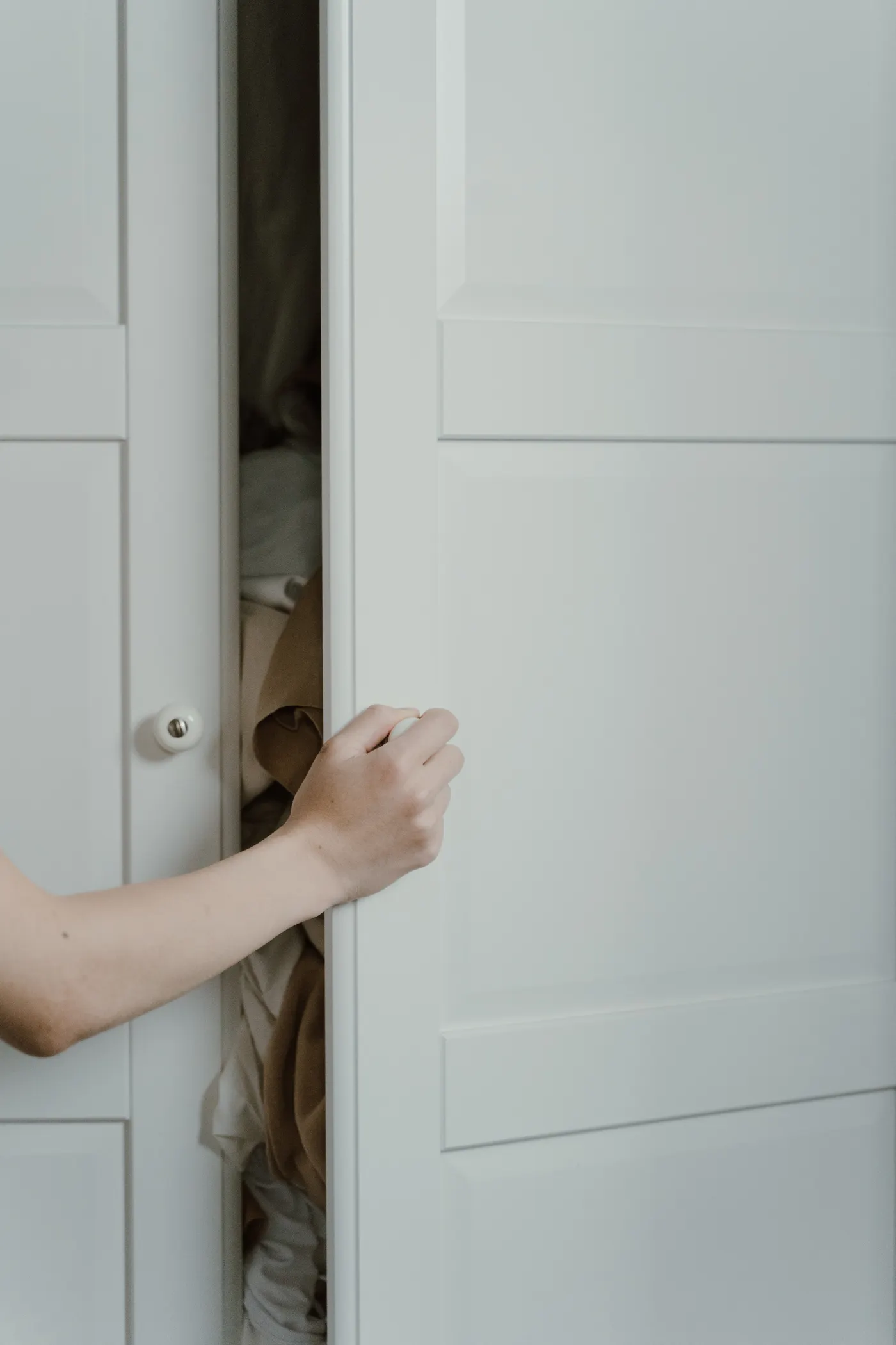 White paneled closet door in a finished interior